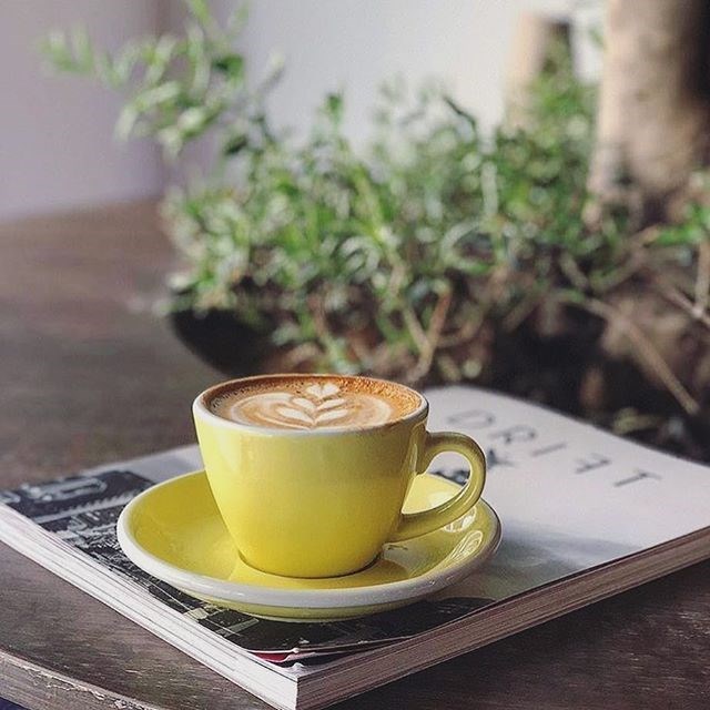 Yellow coffee cup with latte art#