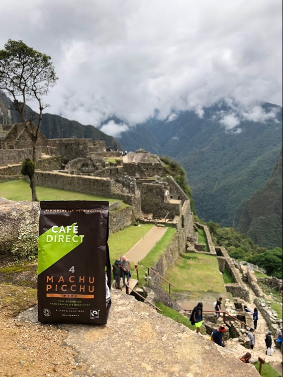 A bag of cafe direct 'Machu Micchu' coffee resting on ledge at Machu picchu site in peru