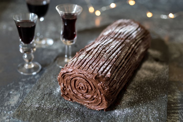 Doves Farm's yule log dusted with icing and served with a glass of port