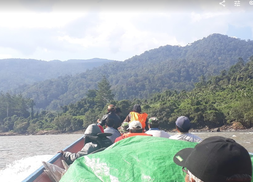 Boat ride in Borneo arriving at the rainforest