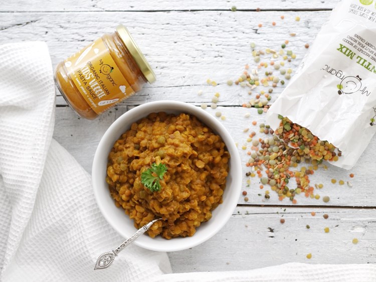 bowl of Mr Orgnaic's curry with pasta sauce jar and lentils