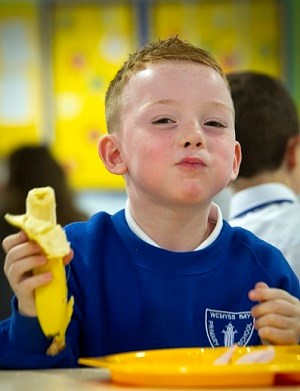 child eating banana