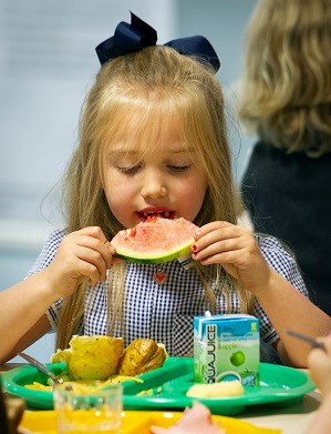 child eating watermelon