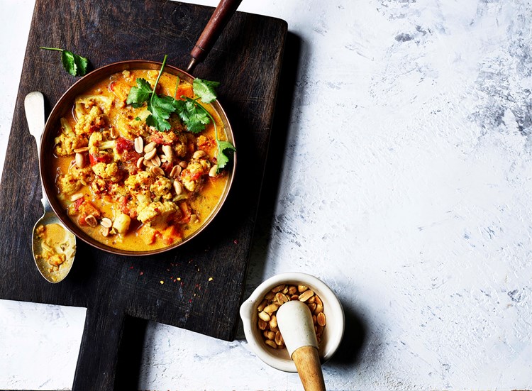 sweet potato and peanut stew served with a side of peanuts