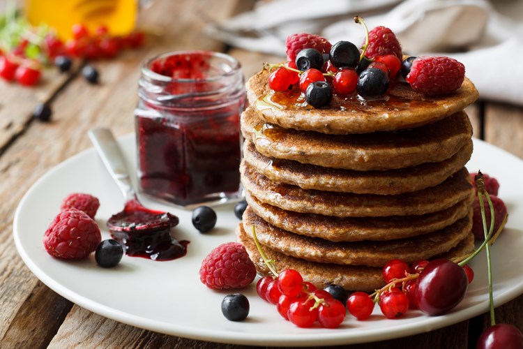 stack of pancakes with blueberries and strawberries