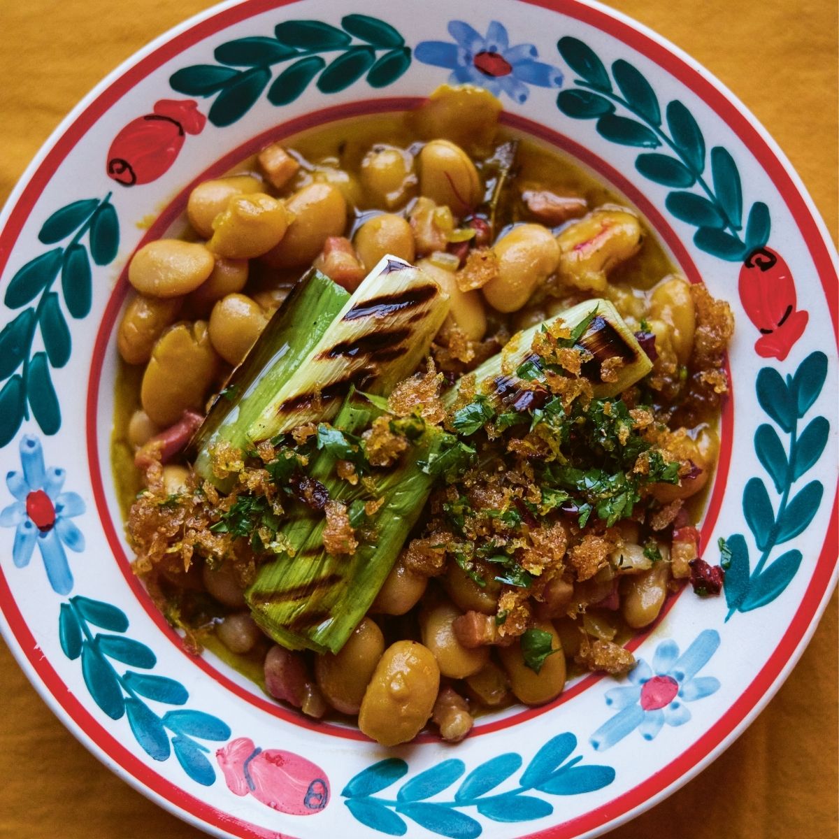 Thomasina Miers' Grilled leeks and white beans with guajilo gremolata crumb  