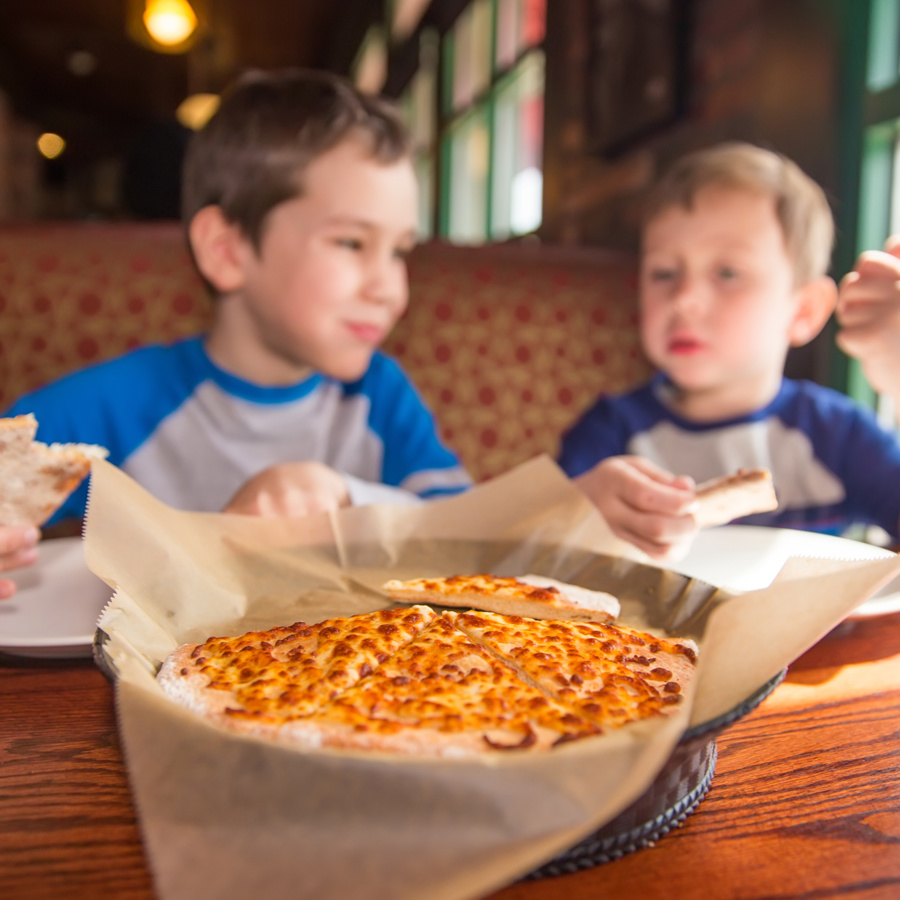 Two children eating pizza