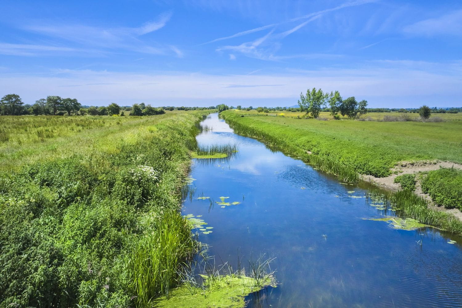 A smooth, straight waterway through low-level fields