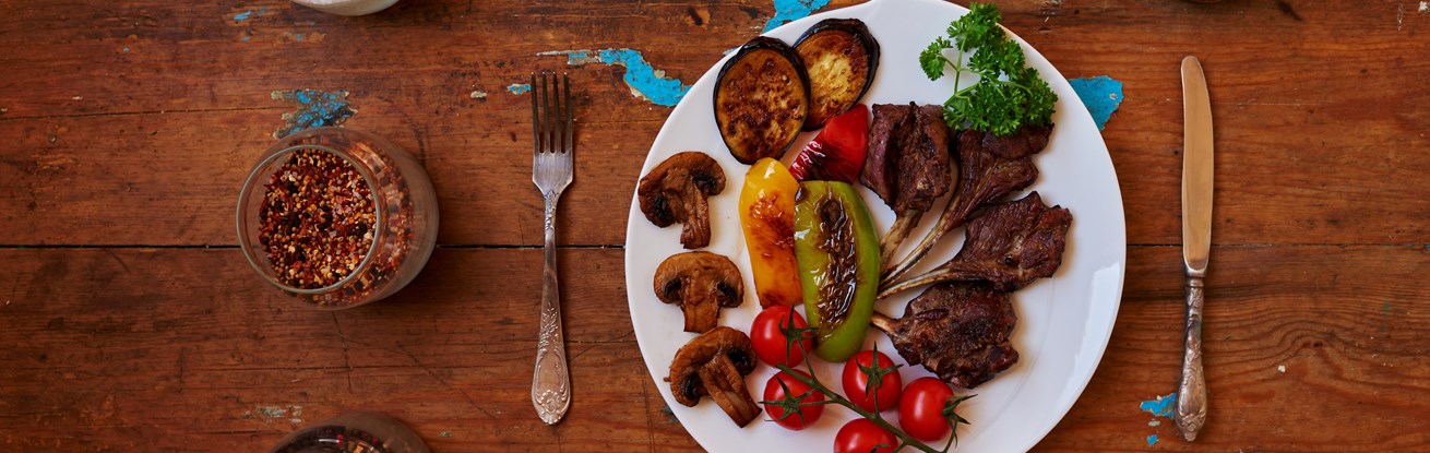 Plate of roasted veg and meat on wooden table.jpg