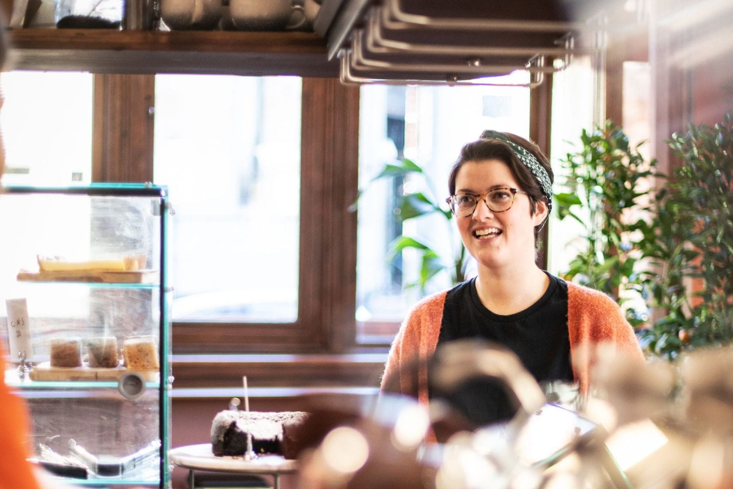A smiling woman in a coffee shop