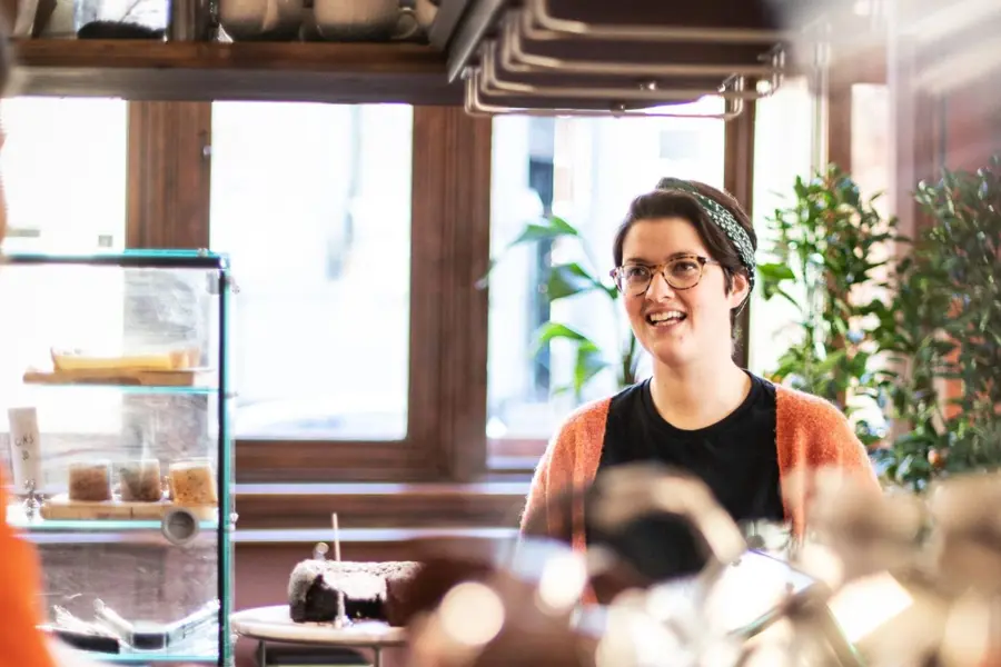 A smiling woman in a coffee shop