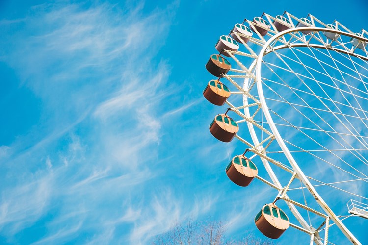 Clear blue sky with a ferris wheel