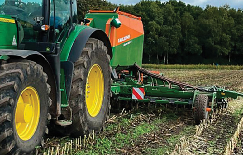 Tractor pulling plough.