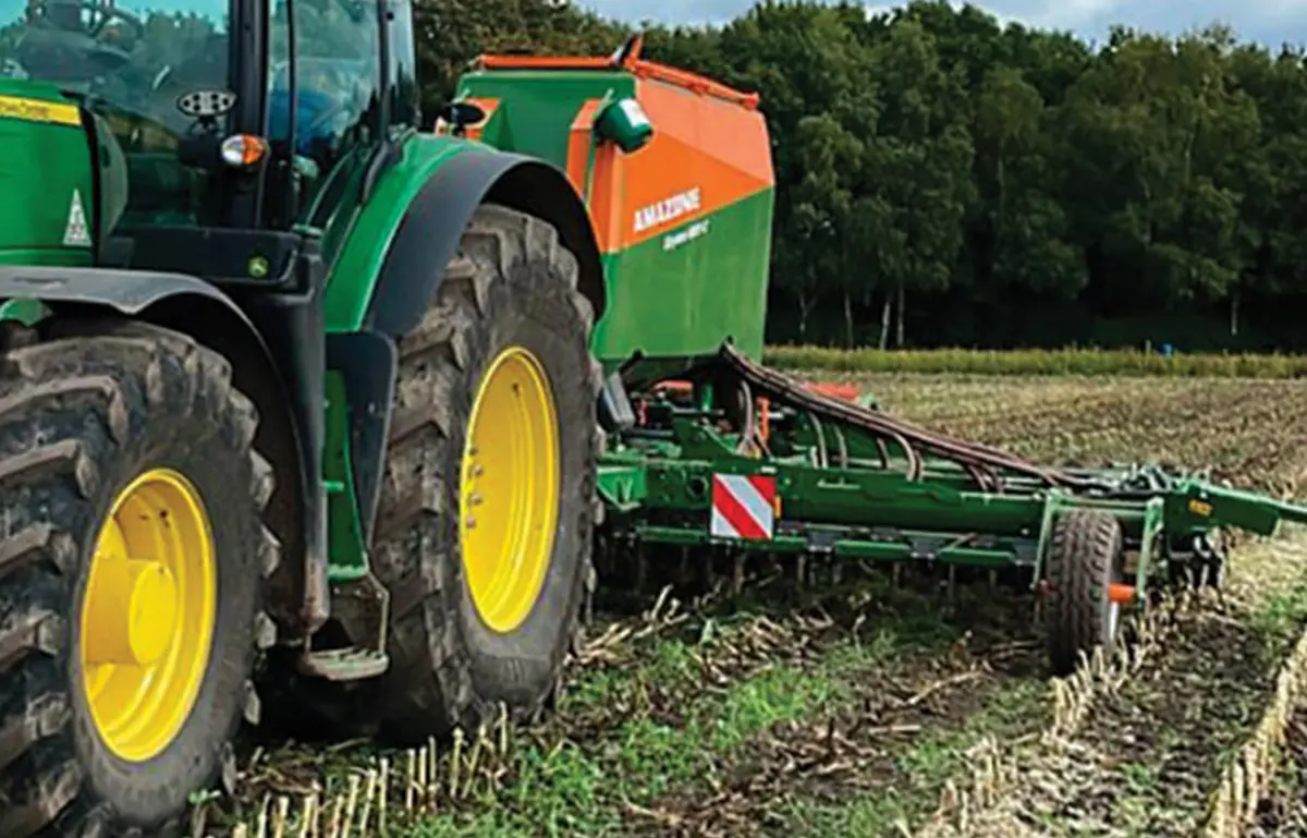 Tractor pulling plough.