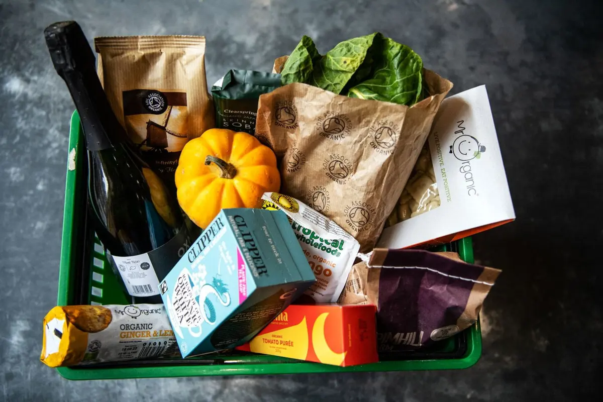 A selection of organic food and drink in a shopping basket