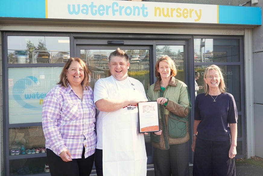 Sue Mcvey Presents The FFLSH Bronze Certifcate To Chef Lukasz Szyszka At Waterfront Nursery