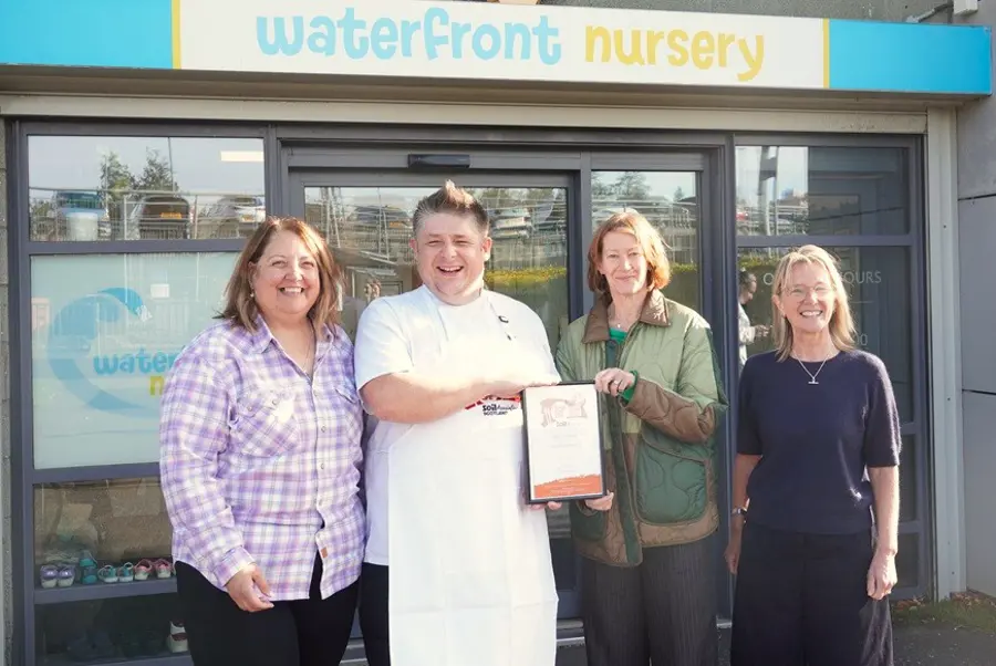 Sue Mcvey Presents The FFLSH Bronze Certifcate To Chef Lukasz Szyszka At Waterfront Nursery