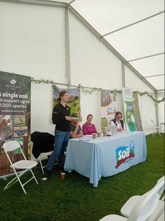 Four people presenting at a conference. 