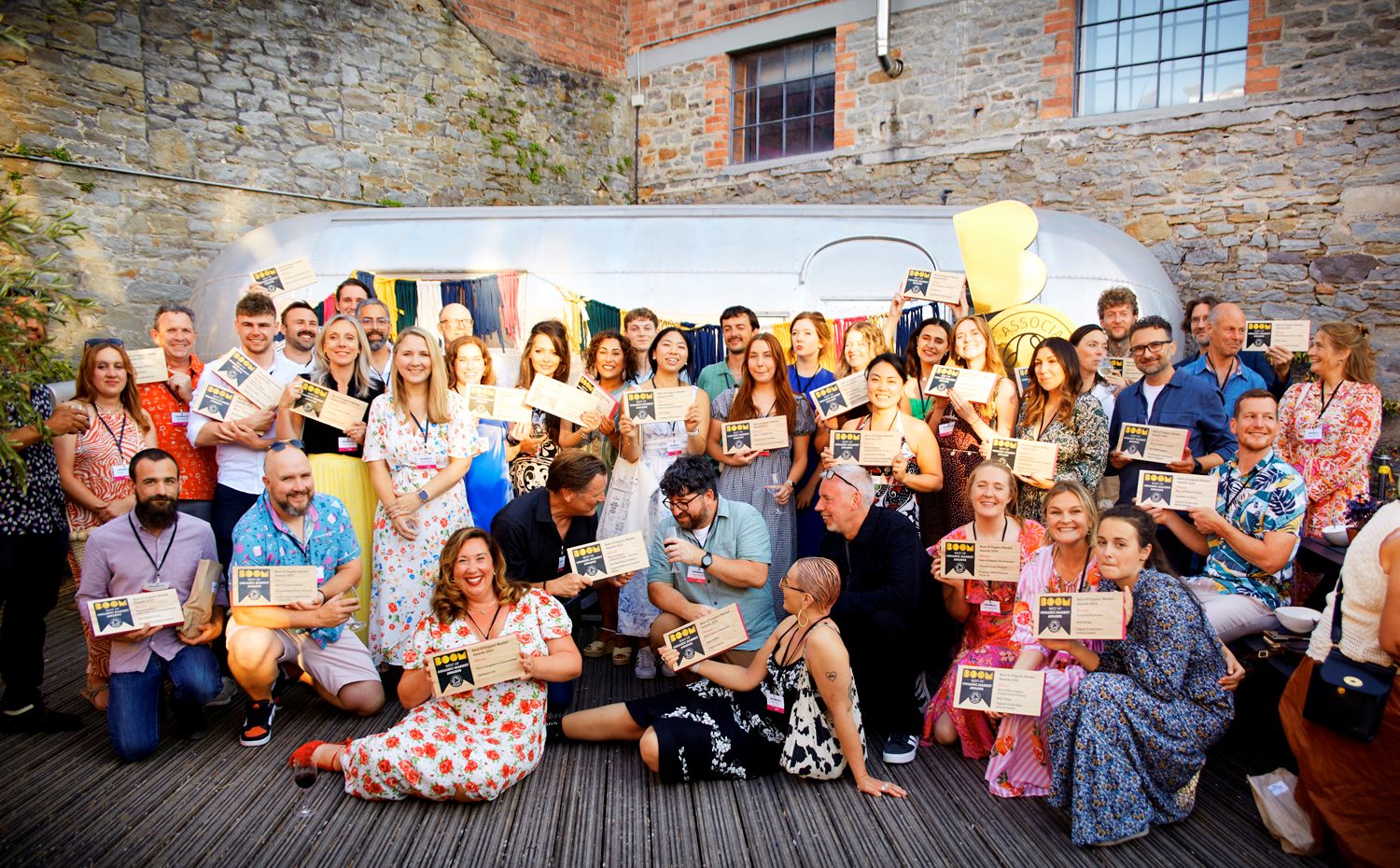 A large group of people holding up their awards