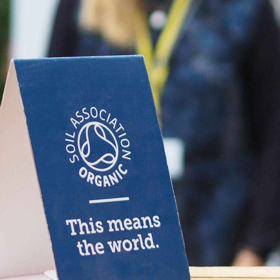 A Soil Association Certification organic branded placard at a conference