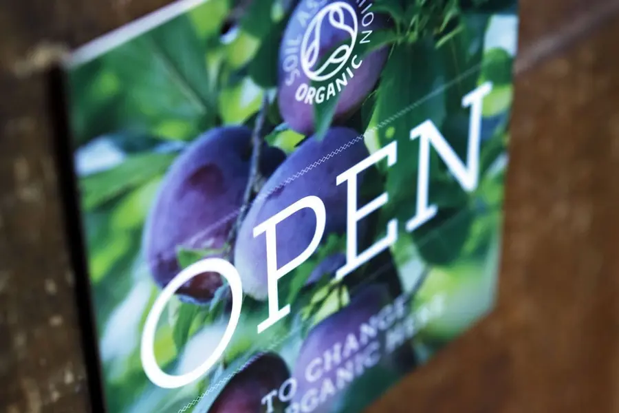 A shop sign bearing the Soil Association organic symbol