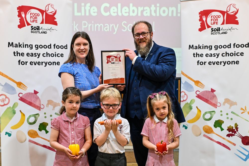 Food for Life Scotland Programme Manager Sarah Gowanlock presents the Food for Life Served Here Bronze certificate to Falkirk Council's Councillor Iain Sinclair