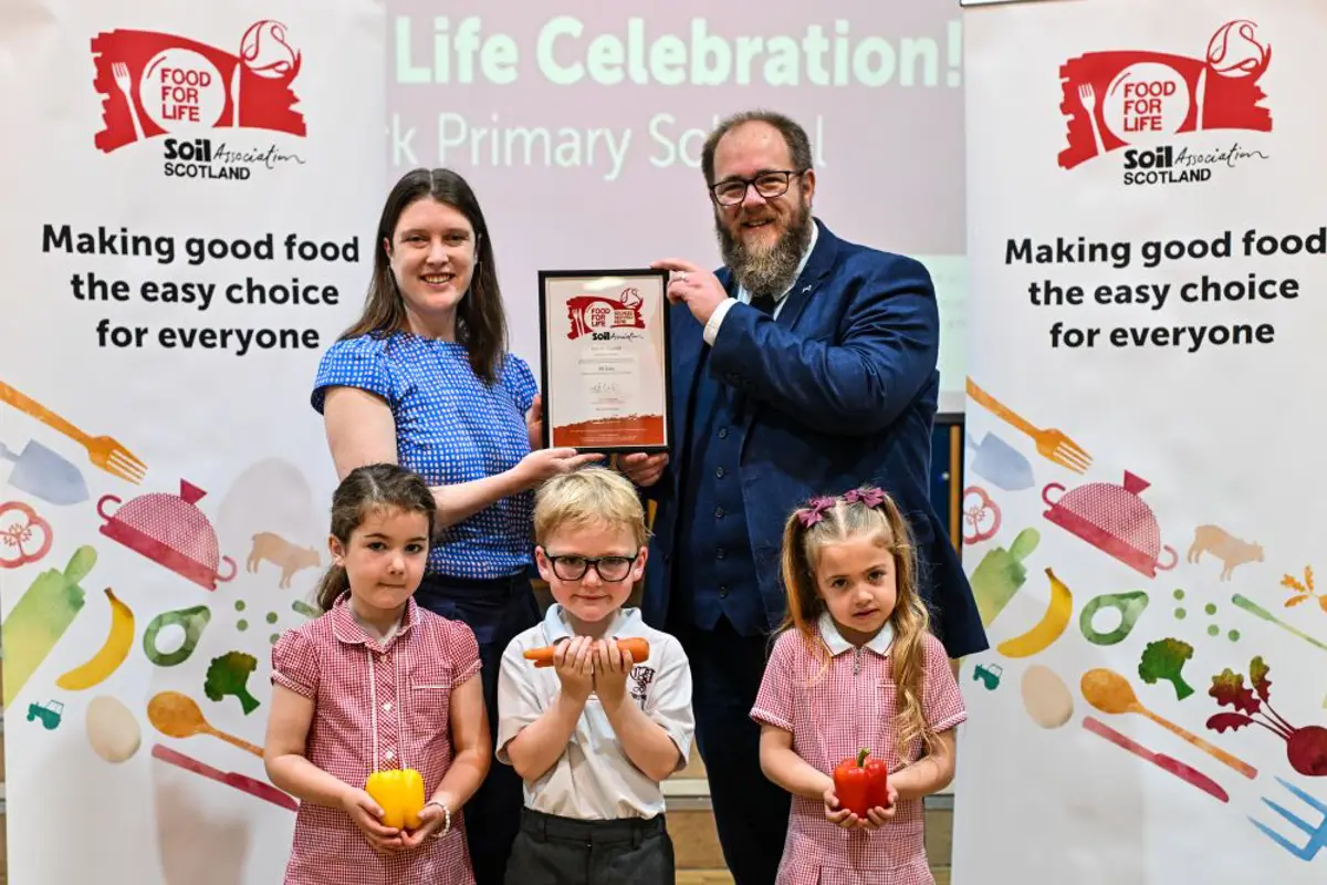 Food for Life Scotland Programme Manager Sarah Gowanlock presents the Food for Life Served Here Bronze certificate to Falkirk Council's Councillor Iain Sinclair