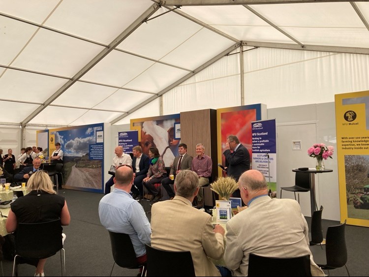 Six people sit in front of audience at National Farmers Union debate taking place at Royal Highland Show.