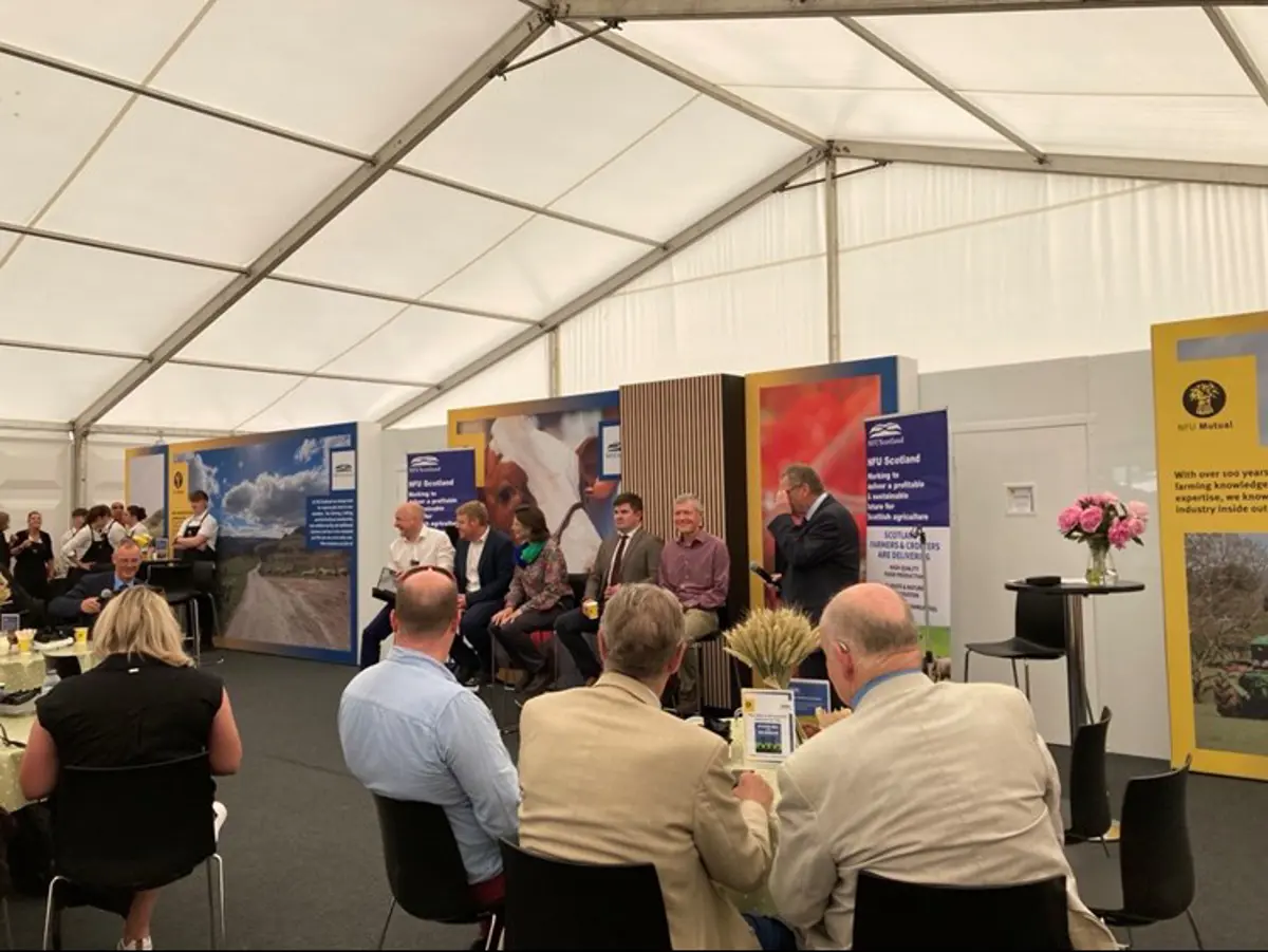 Six people sit in front of audience at National Farmers Union debate taking place at Royal Highland Show.