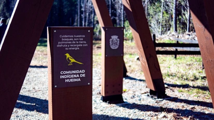 Outdoor signage at Hueima waterfall in Chile