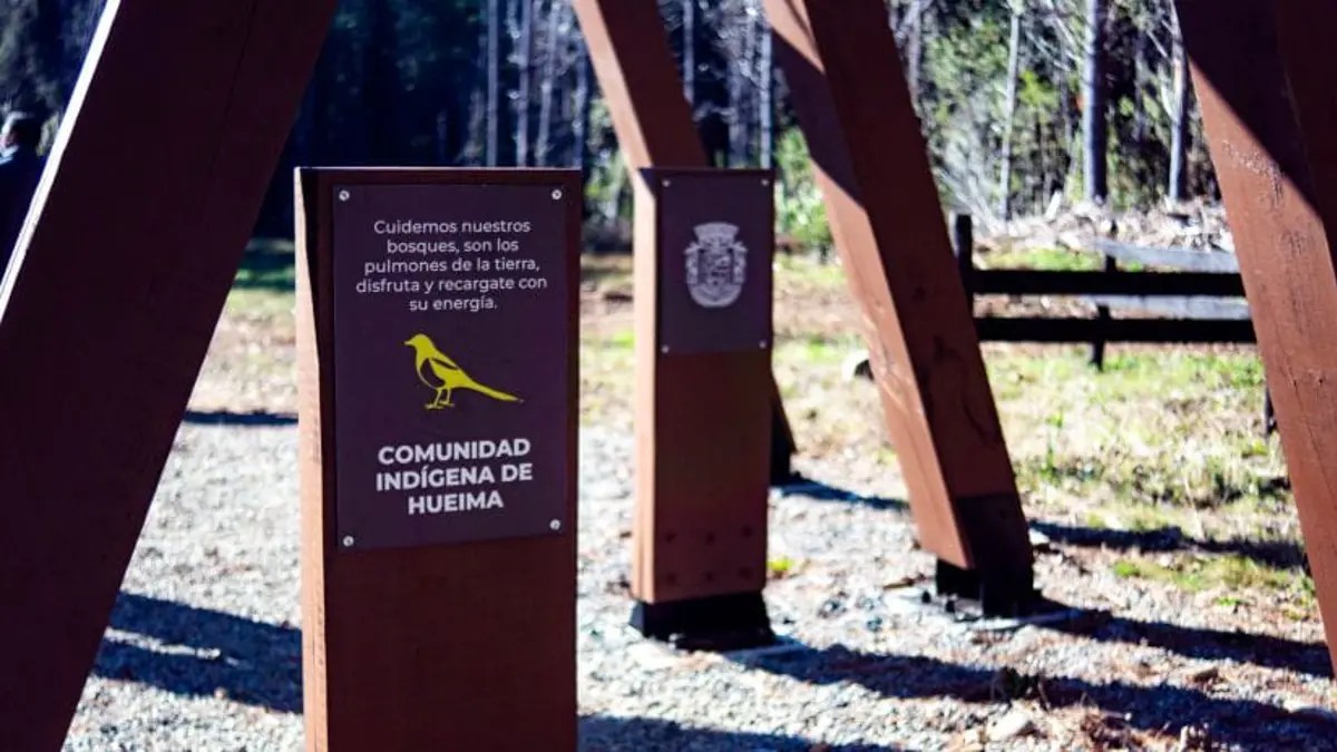 Outdoor signage at Hueima waterfall in Chile