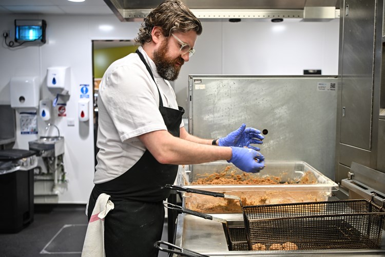 A chef preparing meatballs