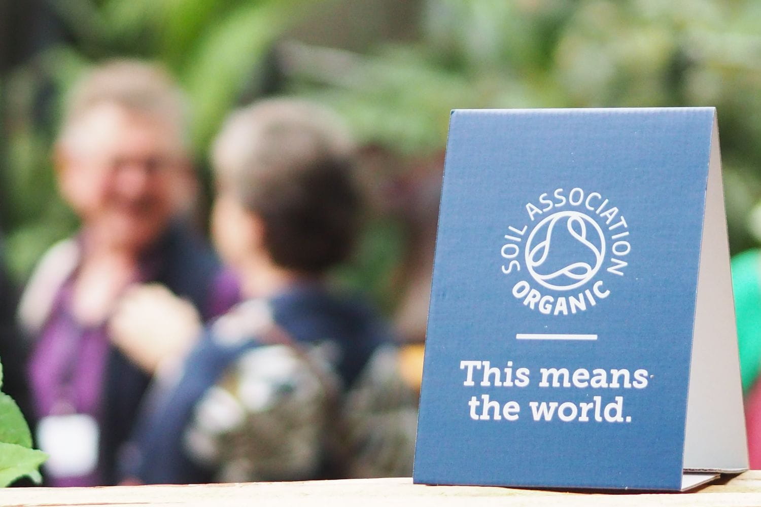 Soil Association Certification signage with people talking in the background