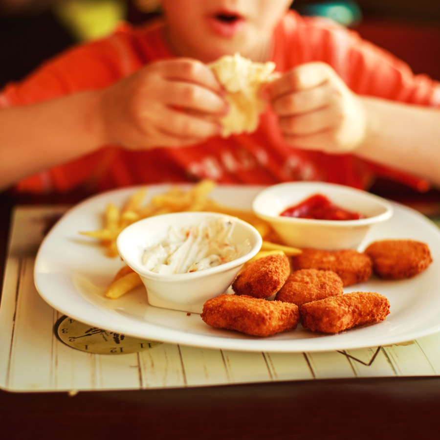 child-eating-chicken-nugg