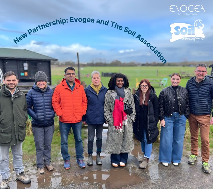 Group of 8 people smiling to camera. 