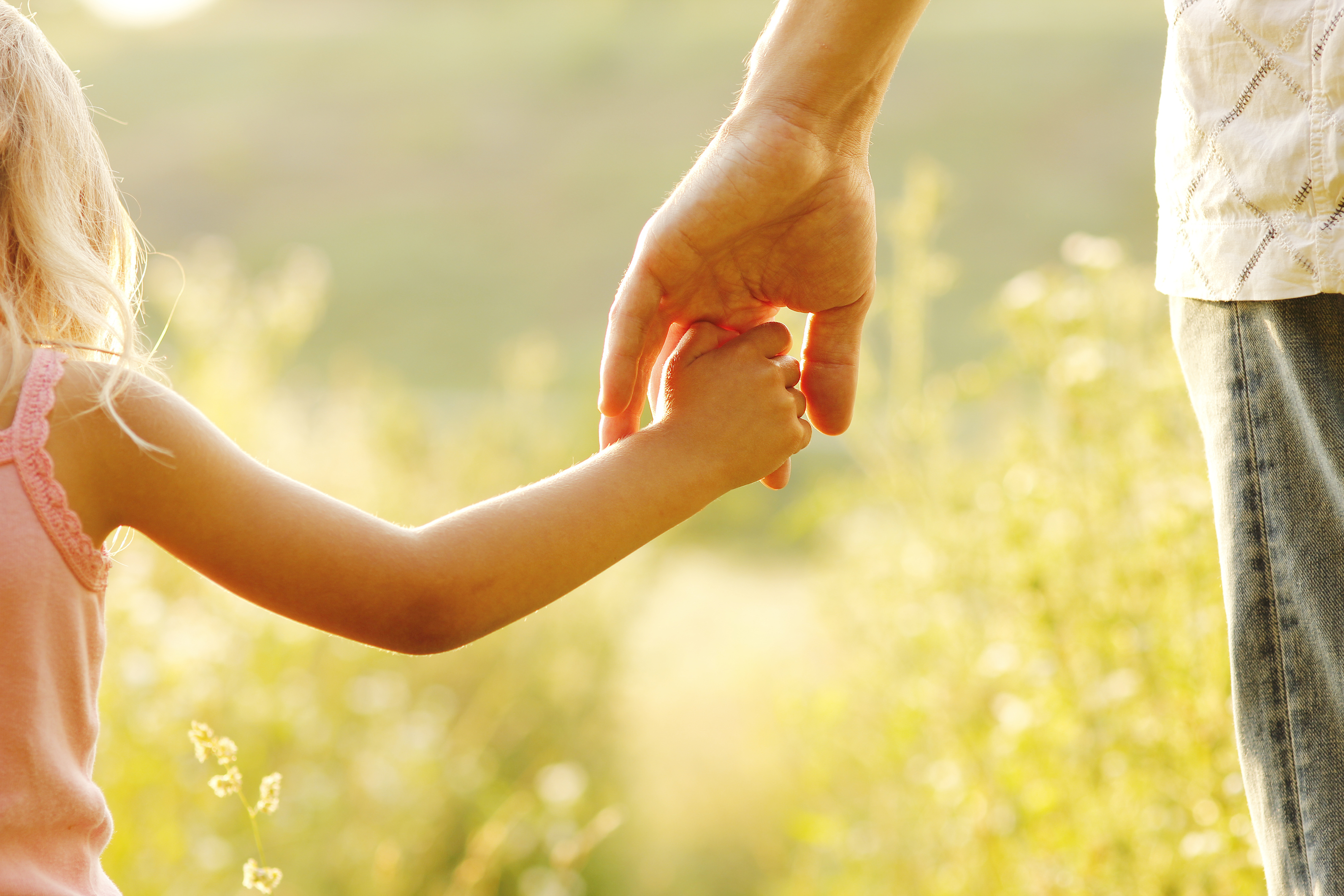 child_and_adult_holding_hand_non_organic