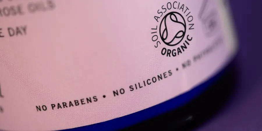The Soil Association organic symbol on a cosmetic bottle which states no parabens and no silicones