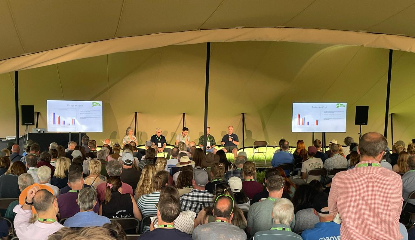 A group of speakers sitting in front of an audience to deliver a talk